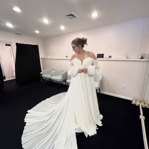 Elegant Off-Shoulder Wedding Gown with Dramatic Train